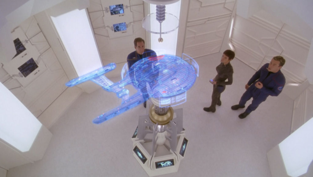 Archer, T'Pol and Trip in a lab looking at a projection of a ship