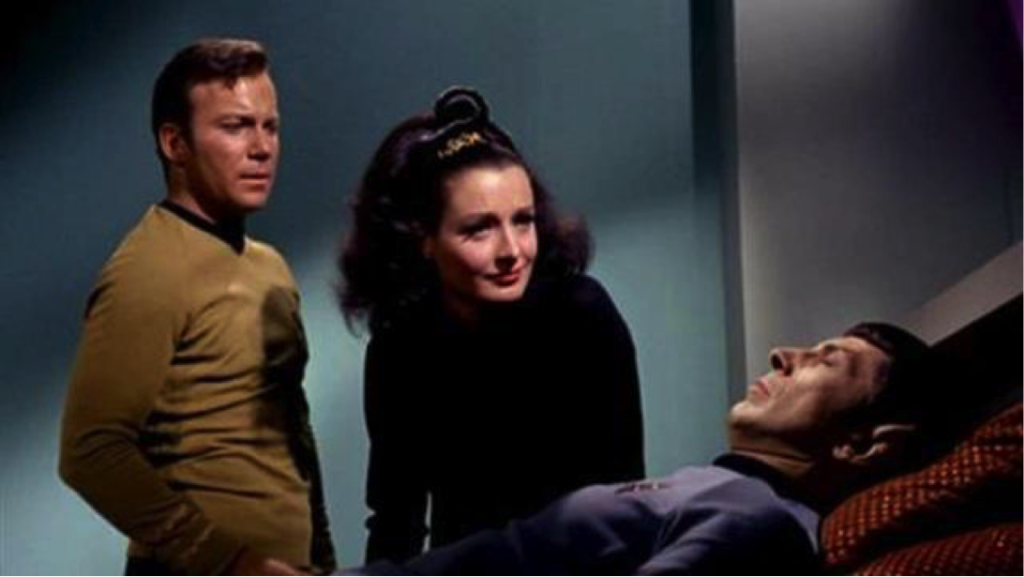 Kirk and Miranda lean over Spock in Sickbay