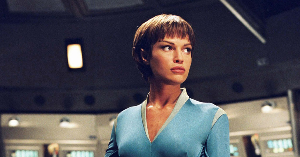 T'Pol in blue uniform standing alone