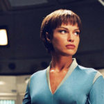 T'Pol in blue uniform standing alone