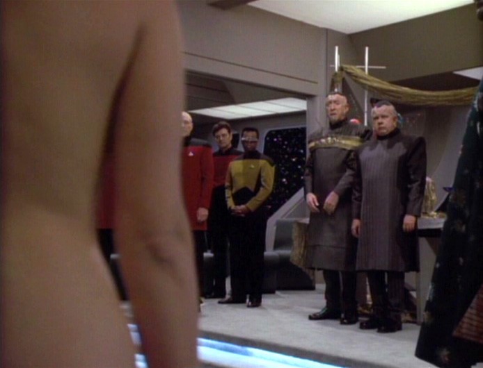 Lwaxana shocks dignitaries by appearing naked to her wedding