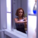 B'Elanna looks at herself in the mirror healing her injured arm