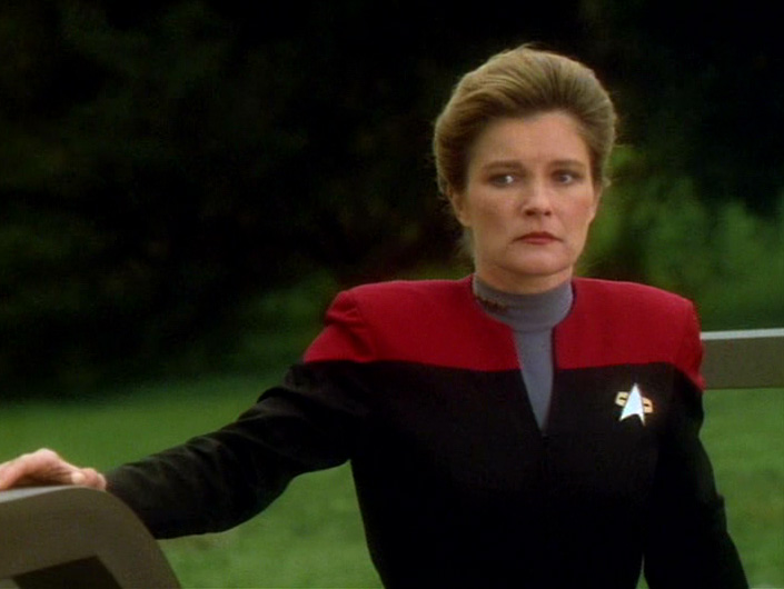 Janeway in her uniform about to leave the planet