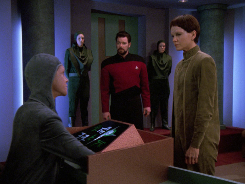 Riker watches Soren speak to the arbitrator at her tribunal