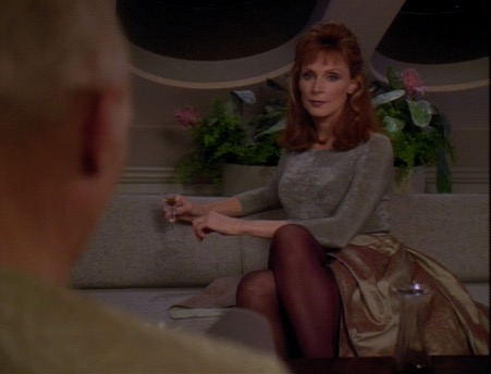 Doctor Crusher off-duty in a voluminous skirt and tights