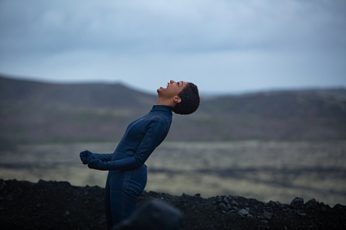 Bunrham kneels on the ground and yells at the sky in triumph for making it safely to the future