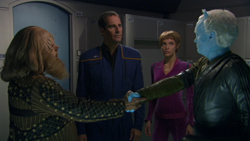 Tellarite and Andorian shake hands while Archer and T'Pol look on