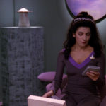 Troi in her office looking at a PADD