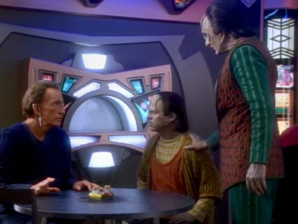 Garak observes Rugal talking to his Bajoran adoptive father