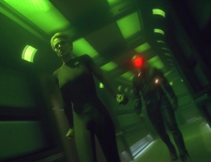 Seven in a corridor during "One", hallucinating she is being followed by a Borg drone