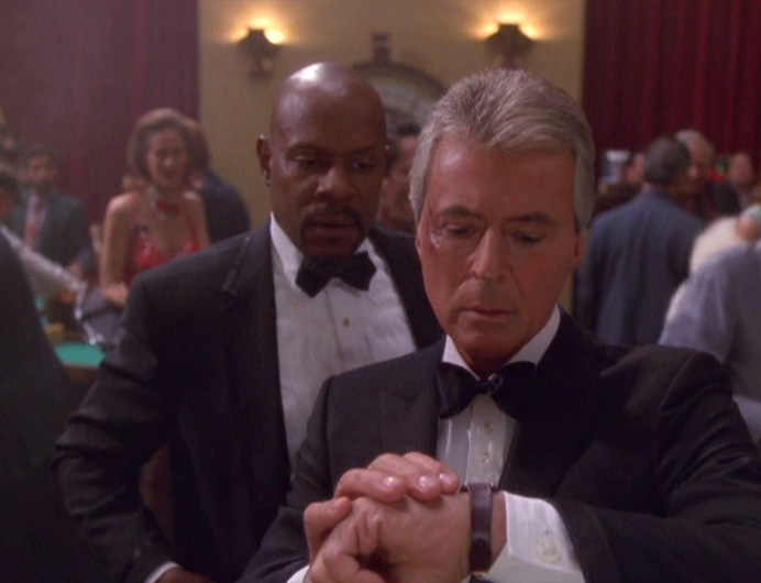 Vic looks at his watch while Sisko looks on in "Badda Bing Badda Bang"