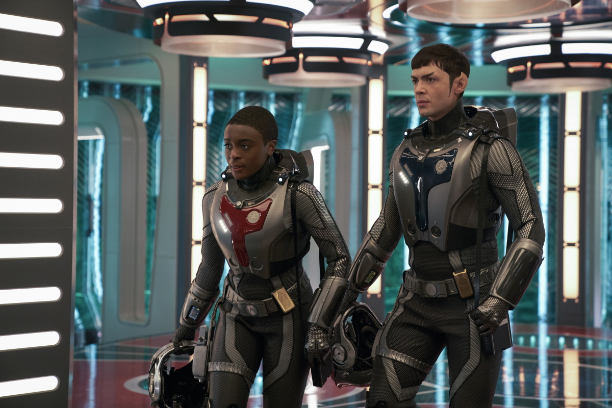 Uhura (Celia Rose Gooding) and Spock (Ethan Peck) step down from the transporter pad.