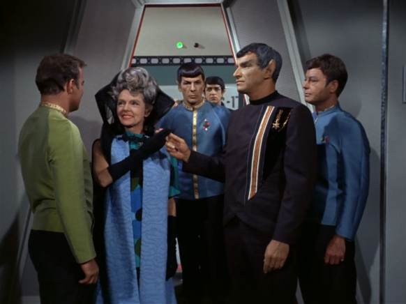 Sarek and Amanda touch fingers in front of Kirk, Spock and McCoy ("Journey to Babel")