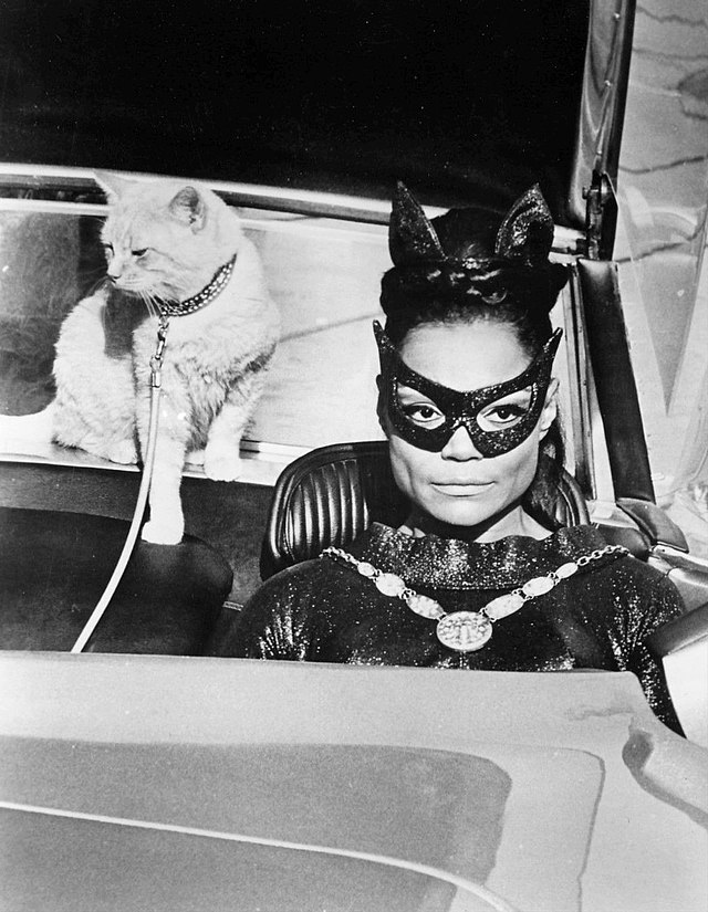 Eartha Kitt as Catwoman in Batman, with an orange cat on a leash