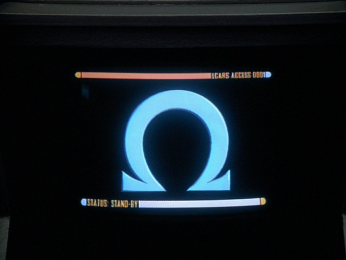 Janeway's screen displays the warning about the Omega particle