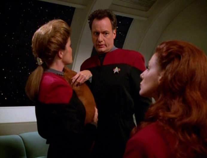 Janeway holds the Irish Setter puppy Q materialized for her, while she talks to Q and Lady Q