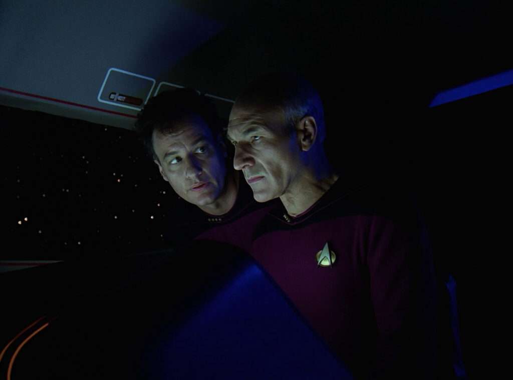 Q leans in close to Picard in the shuttle in "Q Who"